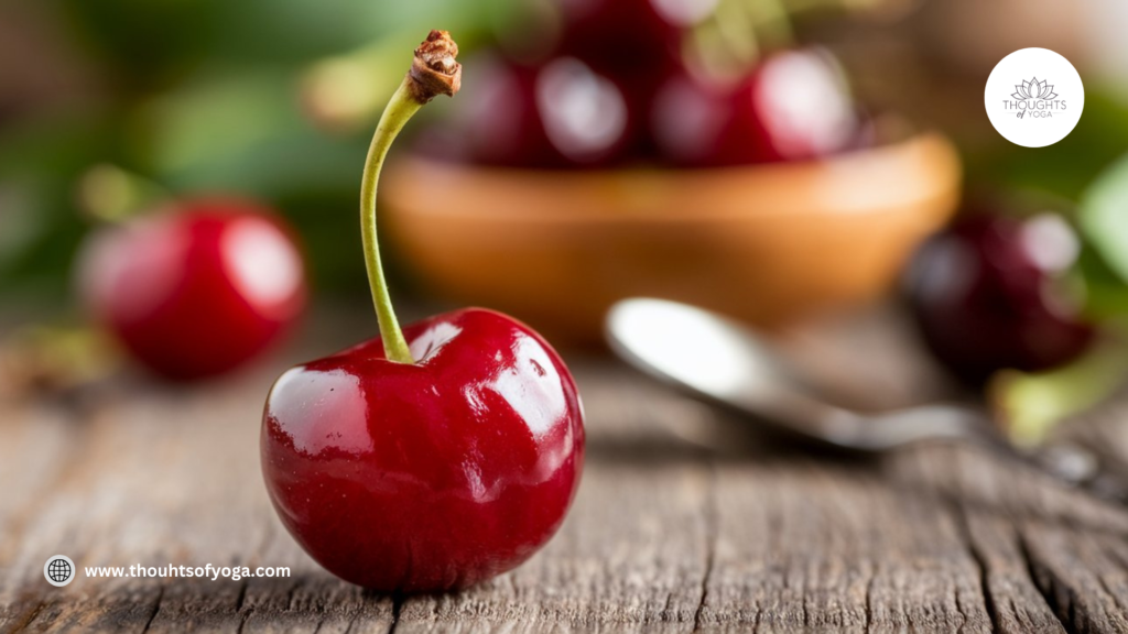 Bowl of ripe, juicy cherries on a wooden table