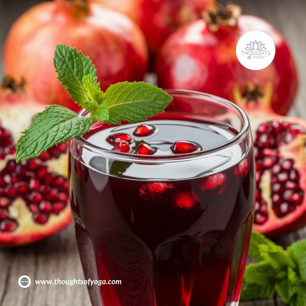 Whole and sliced pomegranate on a wooden cutting board