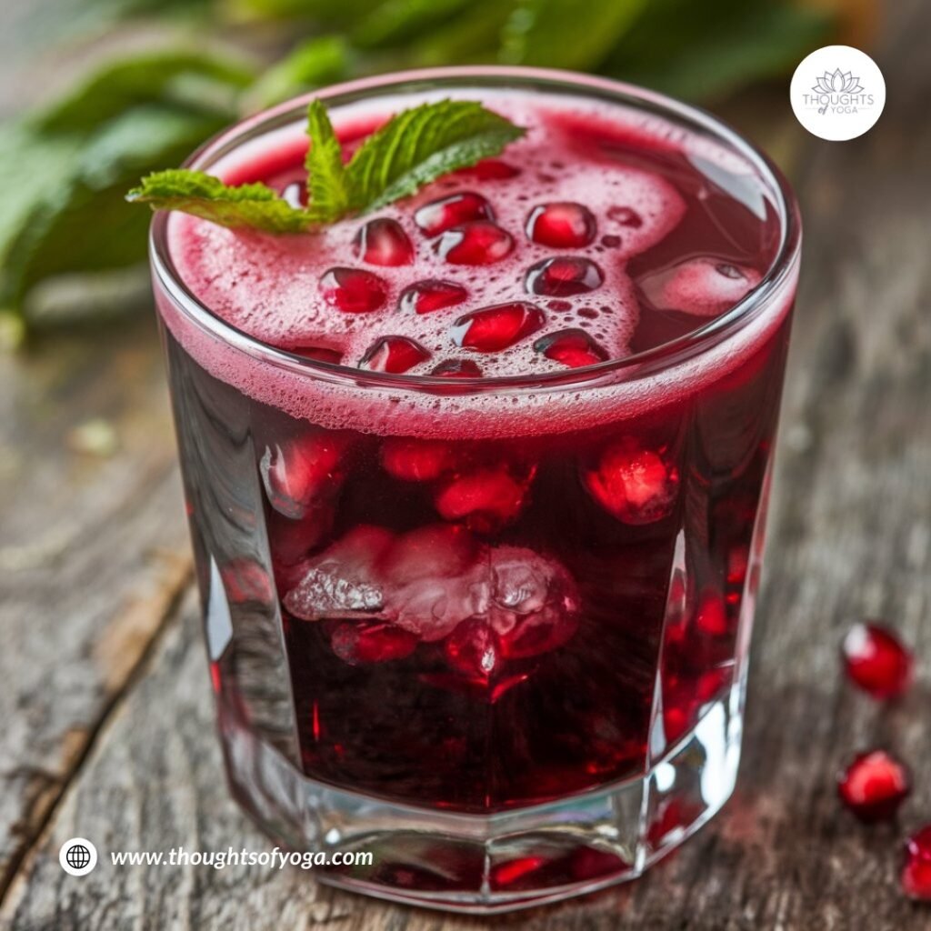 Whole and sliced pomegranate on a wooden cutting board